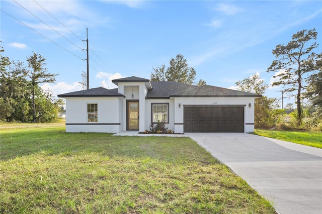 view of front of home with a garage and a front lawn