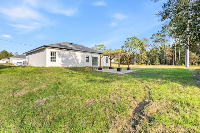 back of house featuring a patio, a lawn, and a pergola