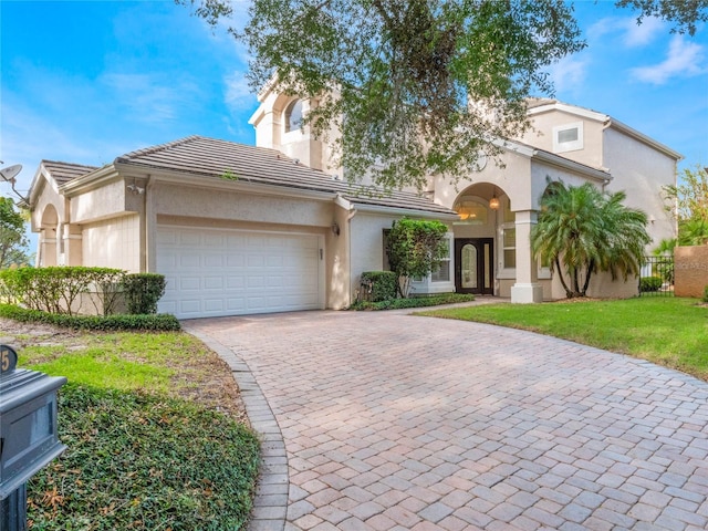 view of front facade with a front yard and a garage