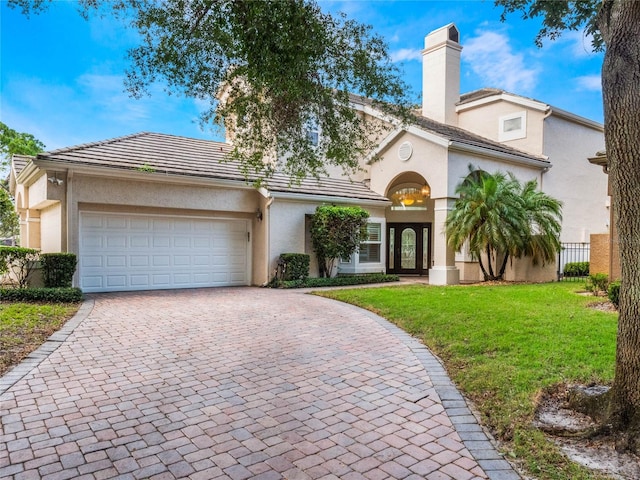 view of front facade with a front lawn and a garage