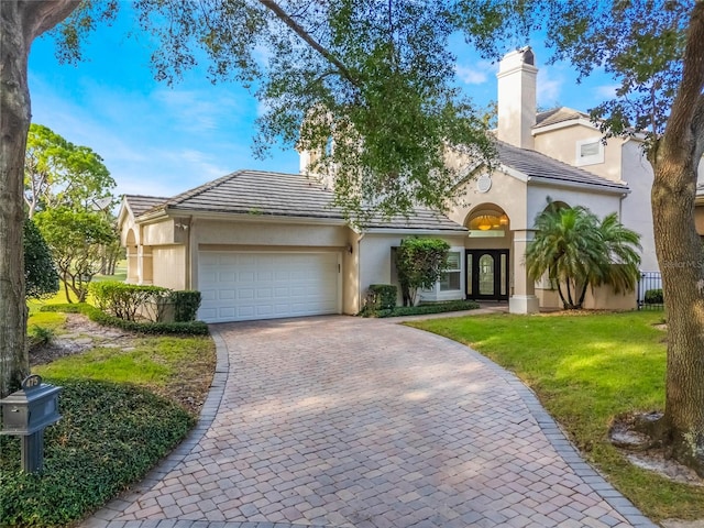 view of front of home featuring a front yard and a garage