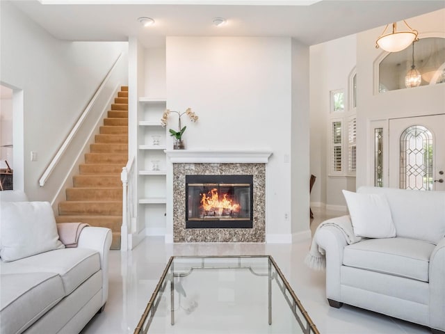 living room featuring a high end fireplace