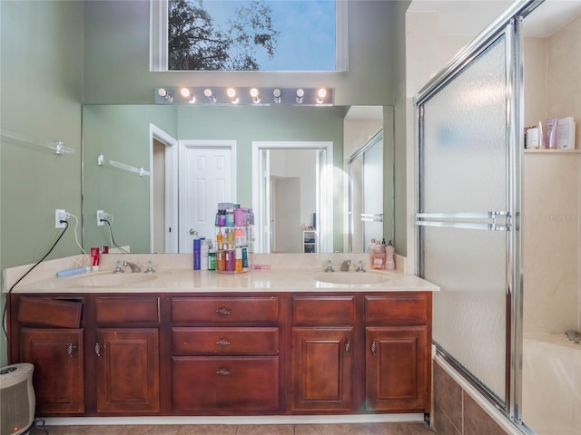 bathroom featuring vanity, tile patterned flooring, and bath / shower combo with glass door