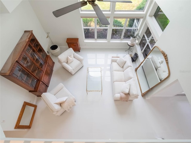 living room featuring a towering ceiling and ceiling fan