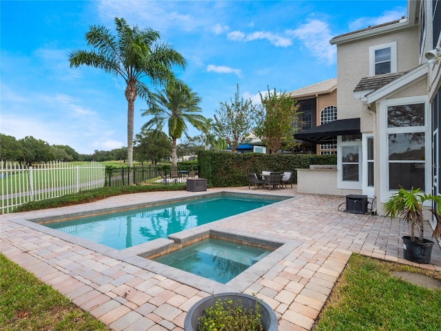 view of swimming pool with an in ground hot tub and a patio area