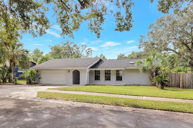 ranch-style house with a front yard and a garage