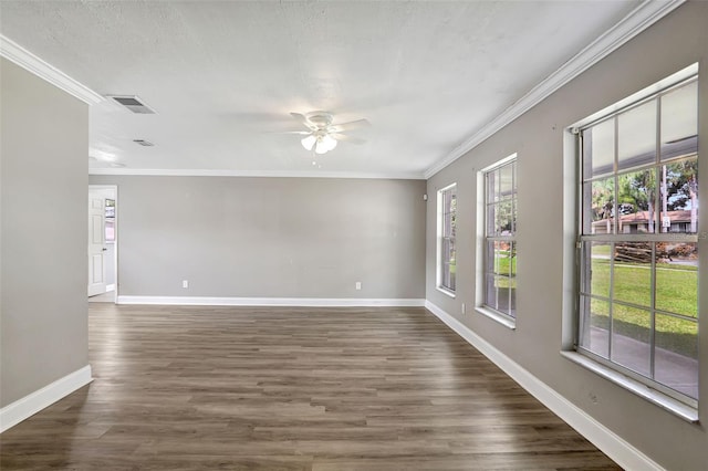 empty room featuring ornamental molding, dark hardwood / wood-style floors, and ceiling fan