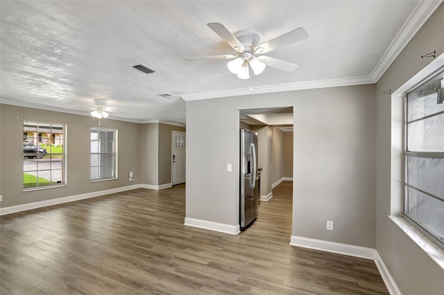 spare room with ceiling fan, hardwood / wood-style flooring, and crown molding