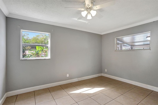 tiled spare room with ornamental molding, a textured ceiling, and ceiling fan