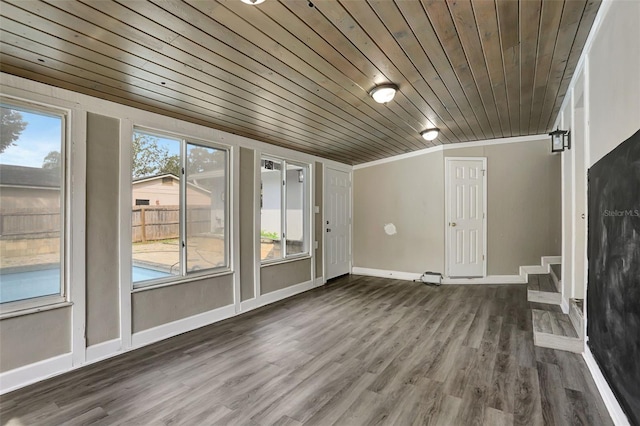 interior space featuring lofted ceiling, hardwood / wood-style floors, wooden ceiling, and plenty of natural light