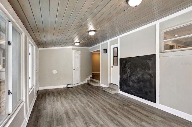 unfurnished living room featuring crown molding, wooden ceiling, and wood-type flooring