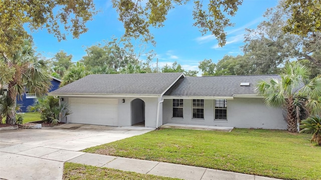 single story home featuring a garage and a front lawn