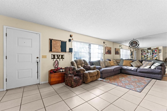 living room with a textured ceiling and light tile patterned floors