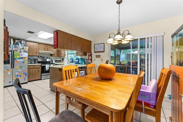 tiled dining space with a notable chandelier