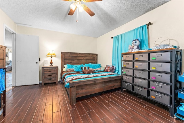 bedroom with dark wood-type flooring, ceiling fan, and a textured ceiling