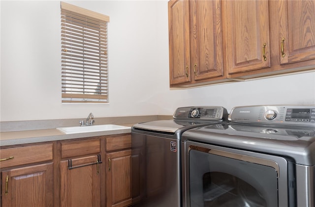 washroom featuring cabinets, separate washer and dryer, and sink