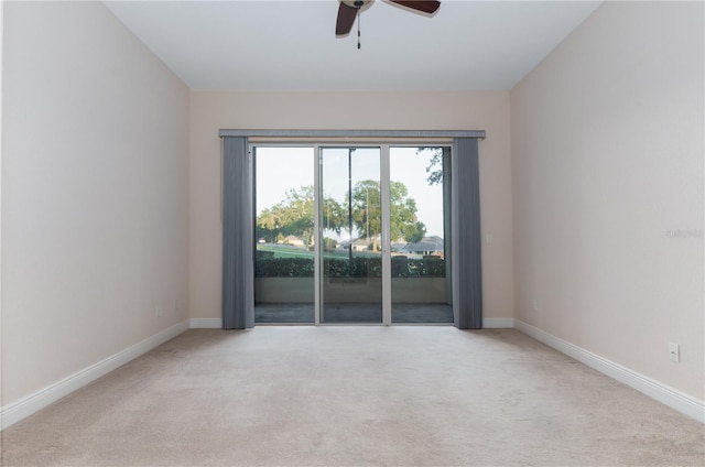 carpeted spare room featuring ceiling fan