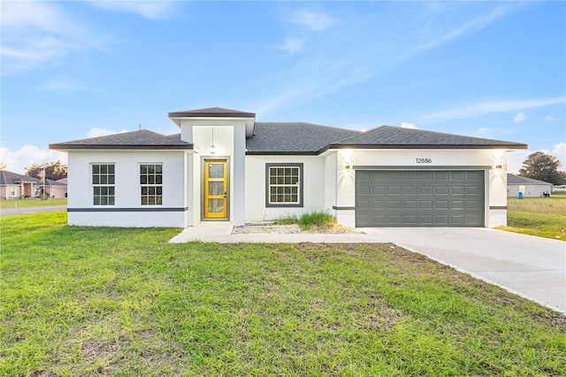 view of front of house featuring a garage and a front lawn