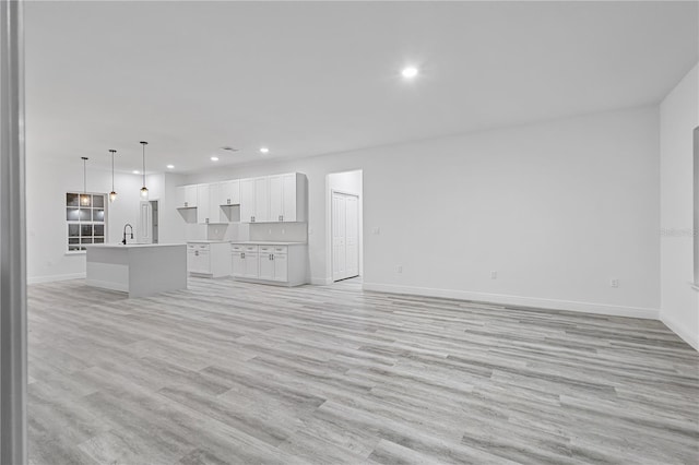 unfurnished living room featuring light wood-type flooring