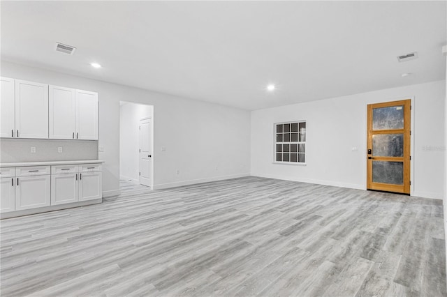 unfurnished living room with light wood-type flooring