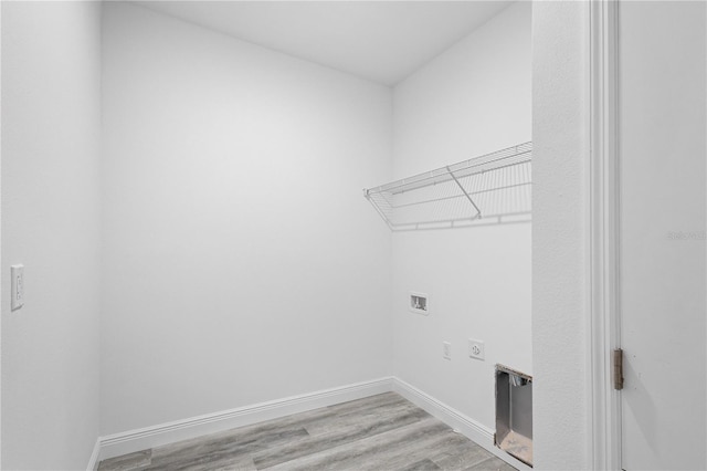 laundry area with electric dryer hookup, washer hookup, and light hardwood / wood-style flooring