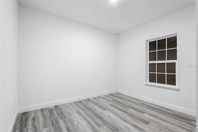 spare room featuring light hardwood / wood-style floors