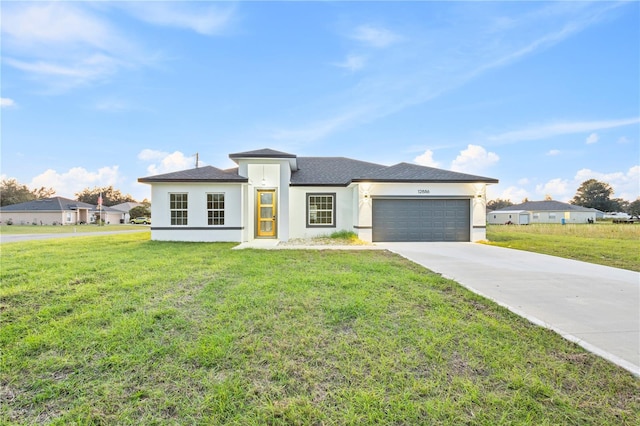 view of front of house featuring a front yard and a garage