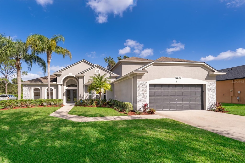 mediterranean / spanish home with a front yard and a garage