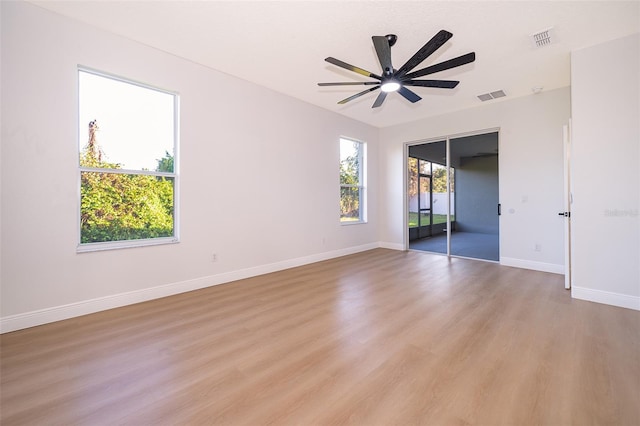 unfurnished room with light wood-type flooring and ceiling fan