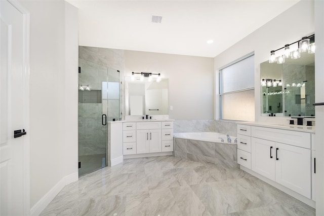 bathroom featuring vanity and independent shower and bath