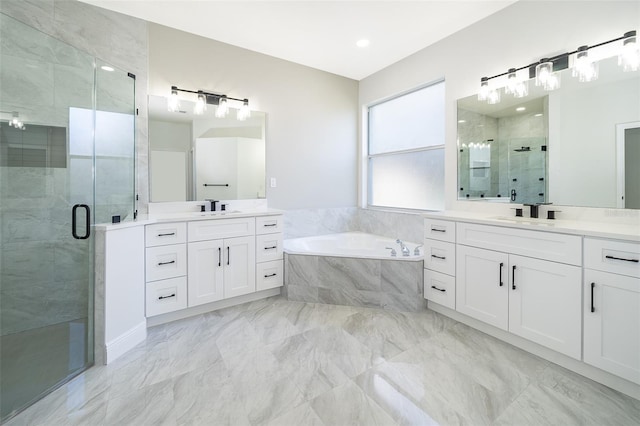 bathroom featuring vanity and shower with separate bathtub