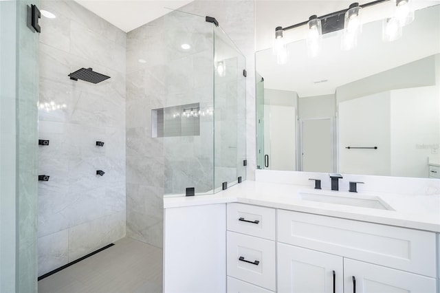 bathroom featuring vanity and a shower with shower door