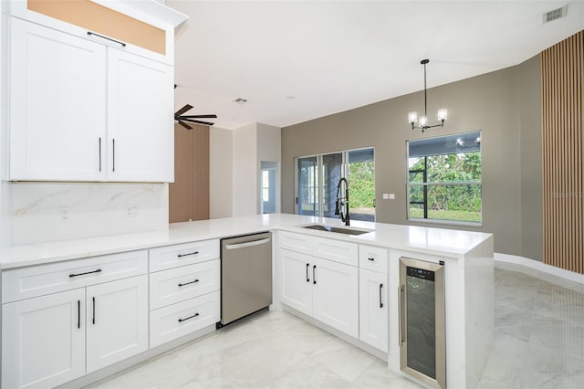 kitchen featuring kitchen peninsula, wine cooler, white cabinetry, dishwasher, and sink