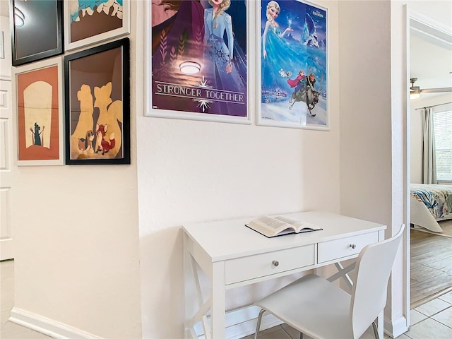 home office with built in desk, light hardwood / wood-style floors, and ceiling fan