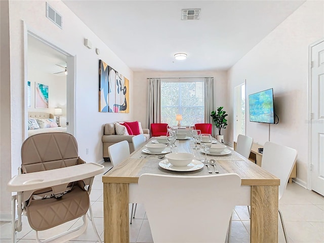 tiled dining space with ceiling fan