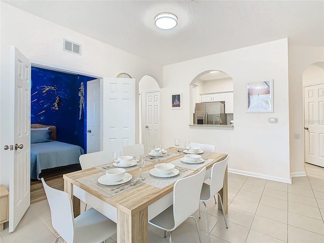 dining area featuring light tile patterned flooring