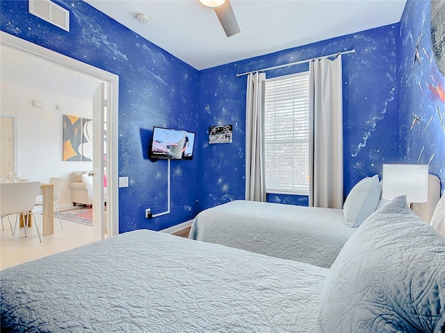 tiled bedroom featuring ceiling fan