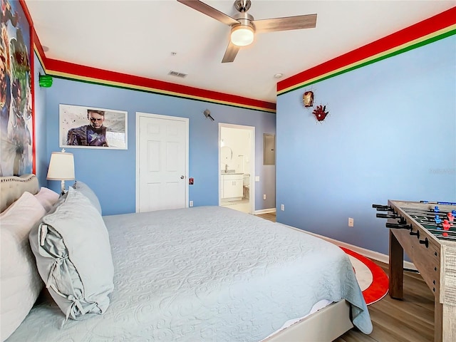 bedroom featuring connected bathroom, hardwood / wood-style flooring, and ceiling fan