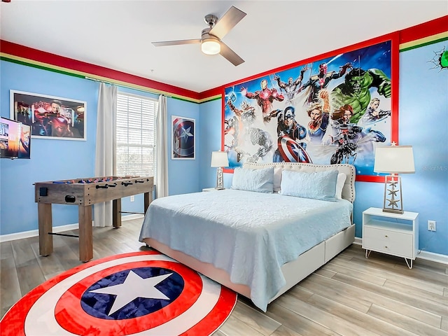 bedroom with ceiling fan and wood-type flooring