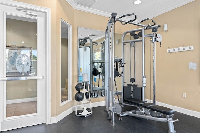 exercise room with ornamental molding and a textured ceiling