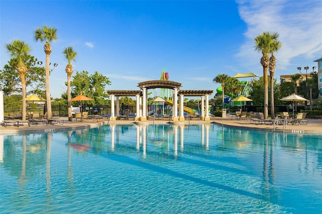 view of swimming pool featuring a patio area and a pergola