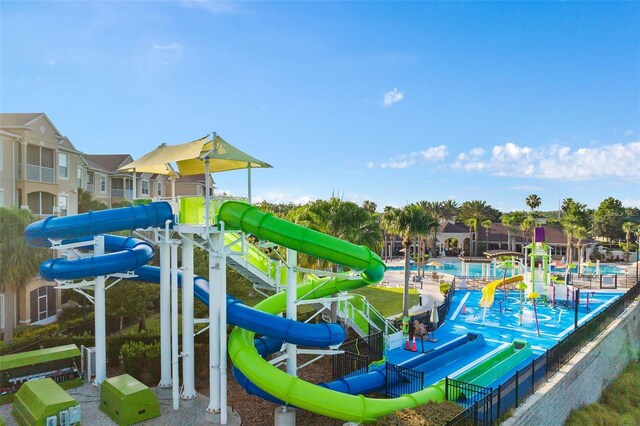 view of playground featuring a community pool and boat lift