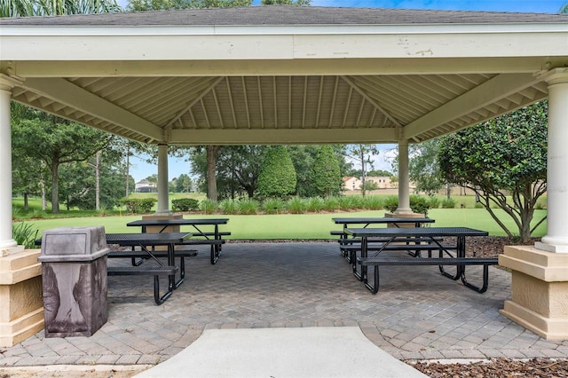 view of community featuring a patio, a gazebo, and a lawn