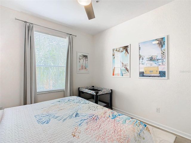 bedroom featuring ceiling fan and multiple windows