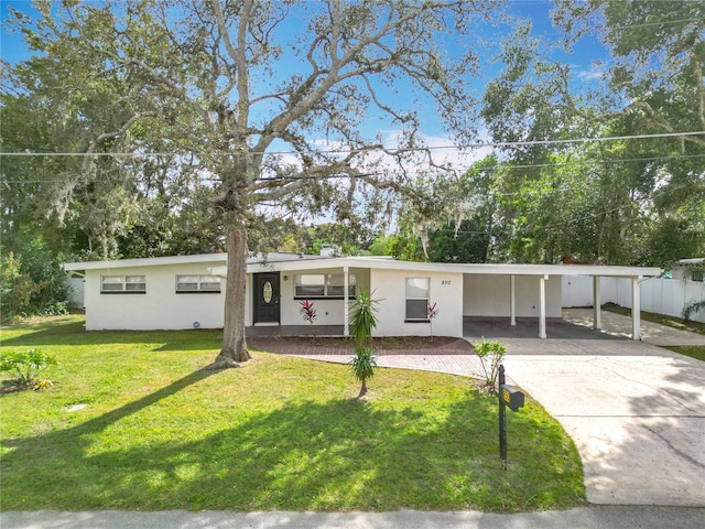 view of front facade with a front lawn and a carport