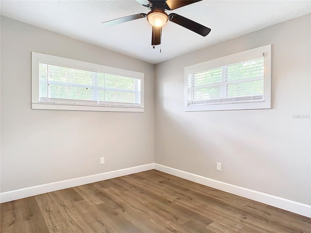 unfurnished room with hardwood / wood-style floors and ceiling fan