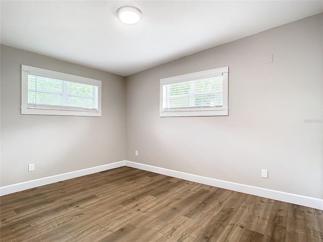 unfurnished room with hardwood / wood-style flooring