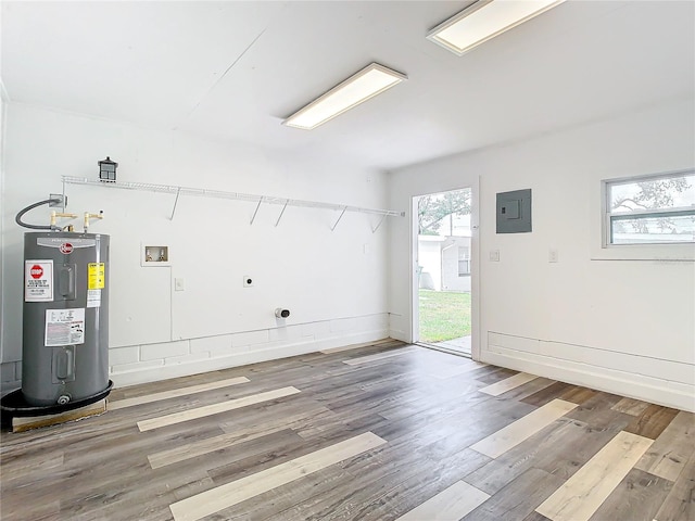 washroom featuring a wealth of natural light, hookup for an electric dryer, water heater, and hardwood / wood-style floors