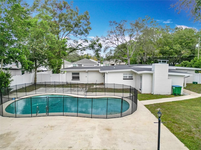 view of pool featuring a patio area and a lawn