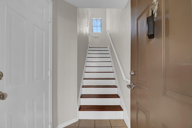 stairway featuring tile patterned floors